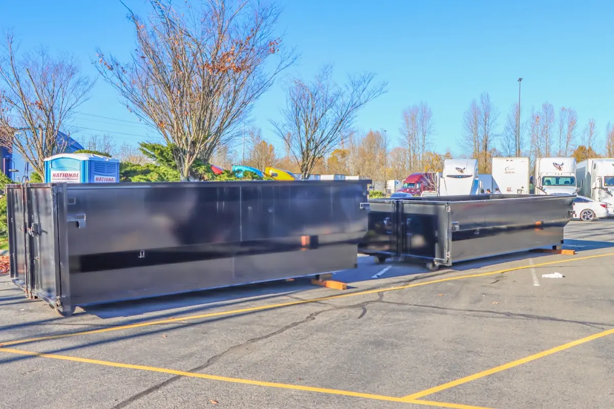 Professional dumpster rental service with roll-off container on residential driveway in Genoa